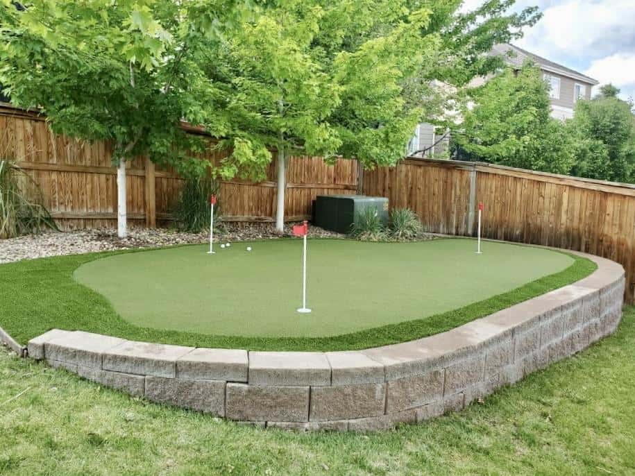 Artificial putting green with contoured landscape design